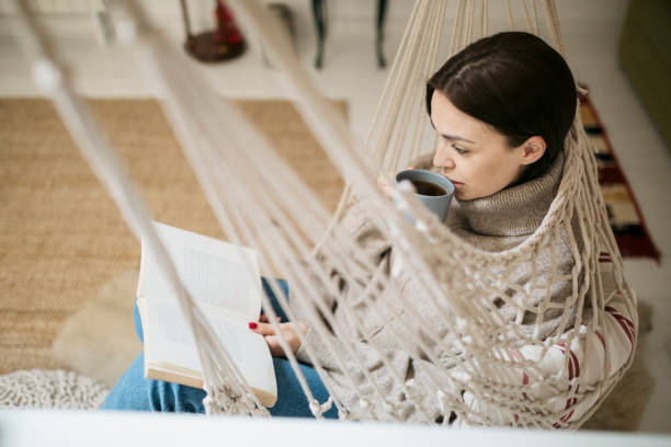 istock Young beautiful woman reading a book 1221081228