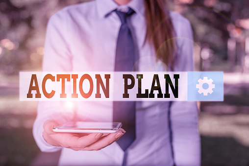 Conceptual hand writing showing Action Plan. Concept meaning detailed plan outlining actions needed to reach goals or vision Business woman in shirt holding laptop and mobile phone