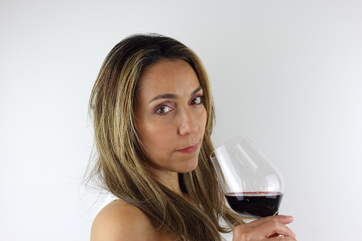 Beautiful Colombian woman with a glass of red wine
