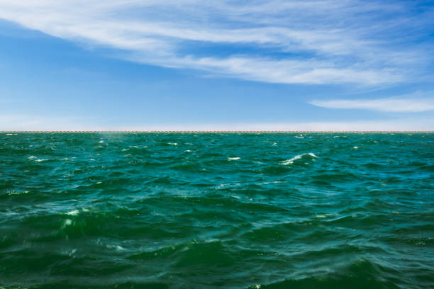 The sea under the blue sky and white clouds background
