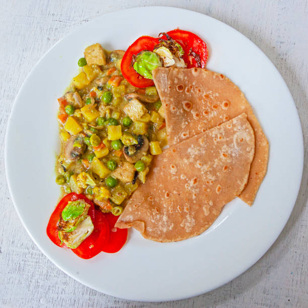 istock Fresh aromatic indian tradition food - vegetable curry with chapatti (roti) 1221093826