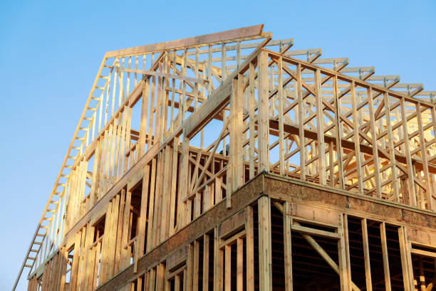 istock Wooden house roof frame structure on a new development 1221093883