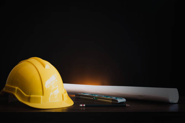 istock real estate, property and construction project concept, engineer's tools  with helmet on table in dark background 1221094975
