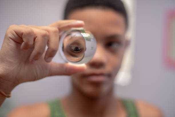 istock Young boy holding crystal ball in hand 1221095643
