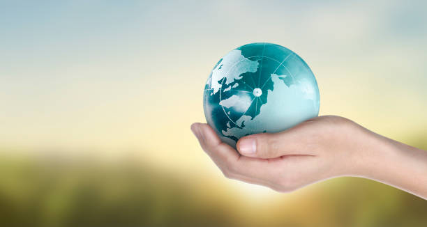 istock Globe , earth in human hand, holding our planet glowing.  image provided by Nasa 1221096327