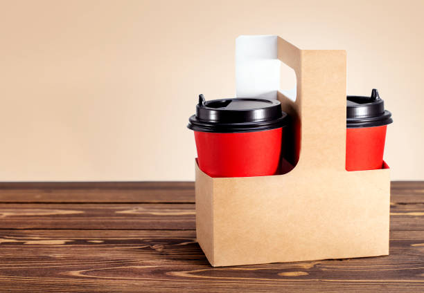 istock Card-box basket with two cup coffee to go on wooden table with place for text. 1221098113