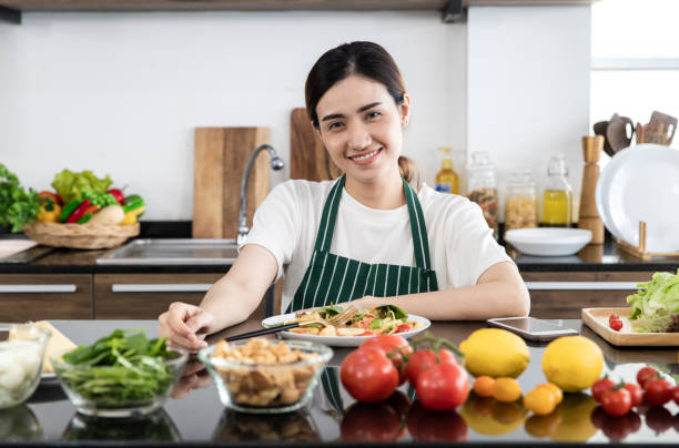 istock Woman eating vegetable salad 1221098219