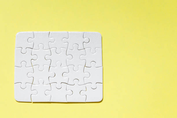 istock jigsaw White puzzle on yellow background top view detail object art 1221099662