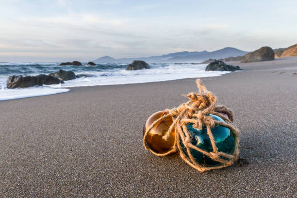Blue glass ball in clear swirling sea water