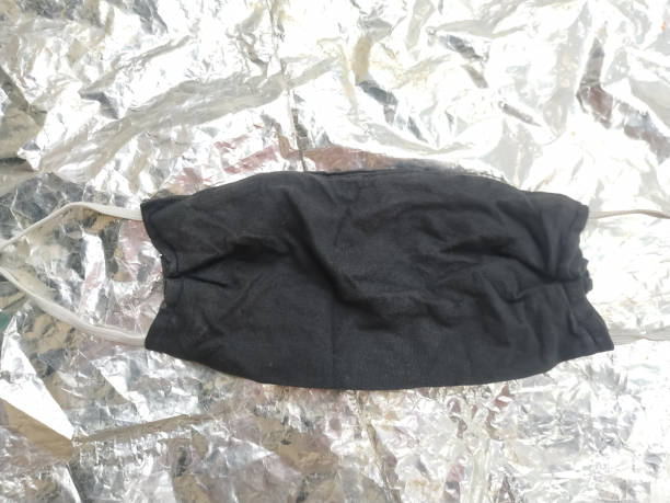 istock Handmade protective mask and piece of cloth on white background. 1221101835