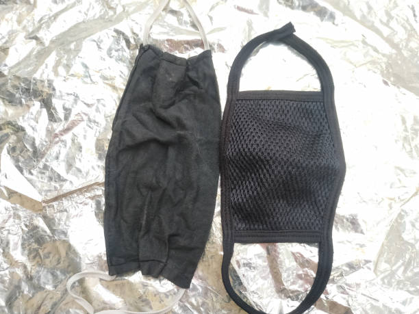istock Handmade protective mask and piece of cloth on white background. 1221101848