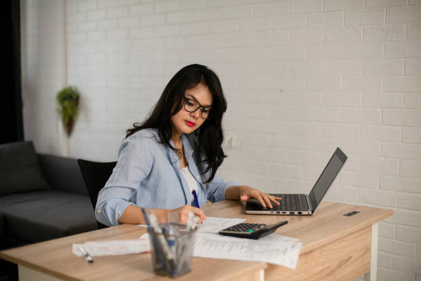 istock Businesswoman calculating data when working from home during coronavirus pandemic 1221102572