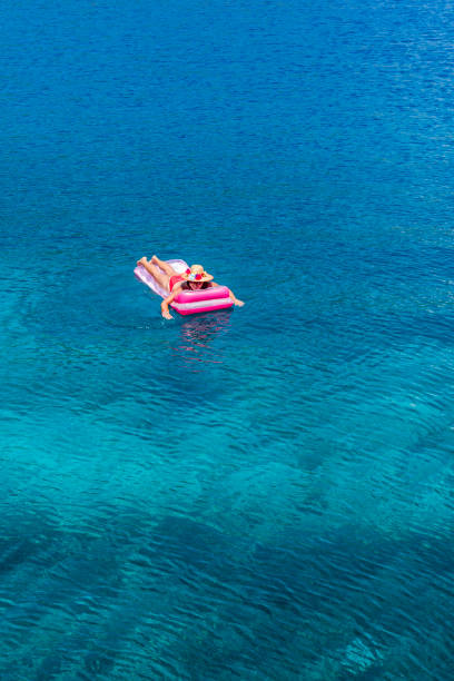 istock Woman sunbathing on the seabed. 1221102661