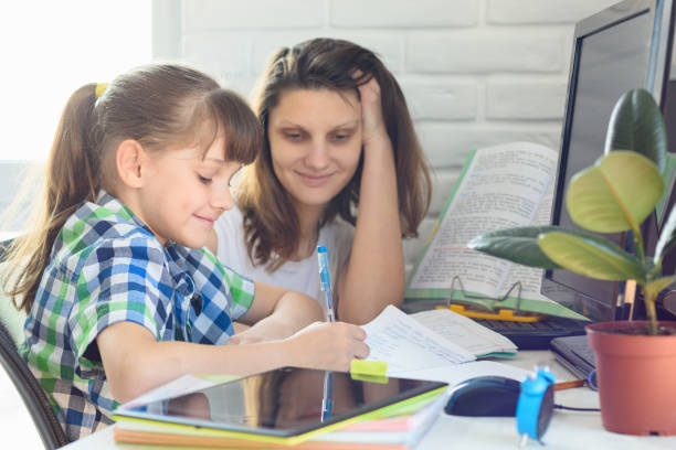 istock Girl and mom do a computer job at home 1221102682