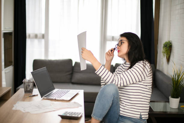 istock Businesswoman calculating data when working from home during coronavirus pandemic 1221102713