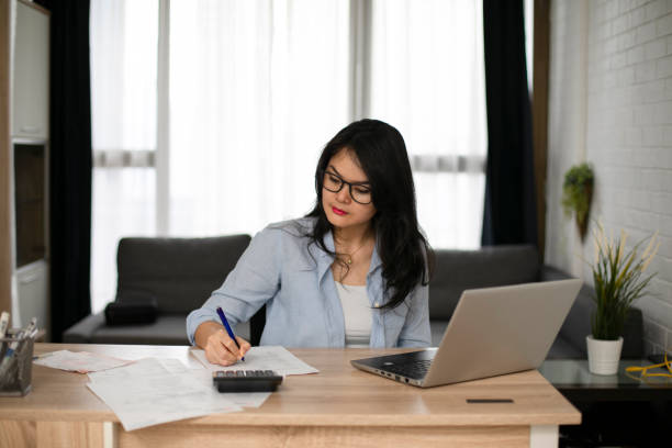 istock Businesswoman calculating data when working from home during coronavirus pandemic 1221102754