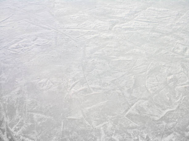 istock ice skating rink with flacks of ice and ice skating blade marks 1221103445
