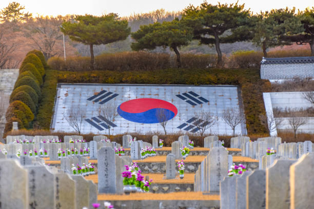 granite gravestones with commemorable flowers in seoul national cemetery taken during winter