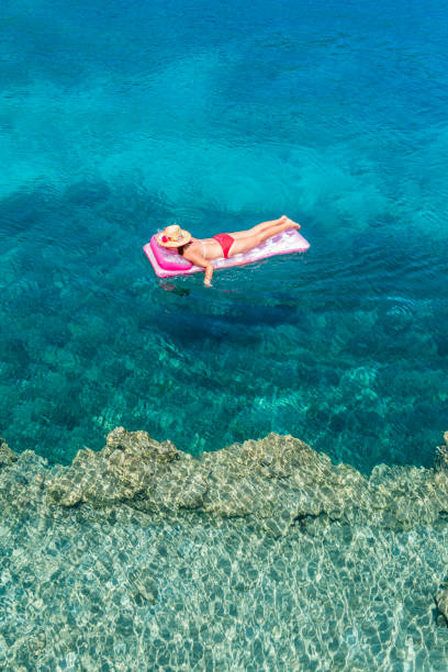 istock Woman sunbathing on the seabed. 1221113193