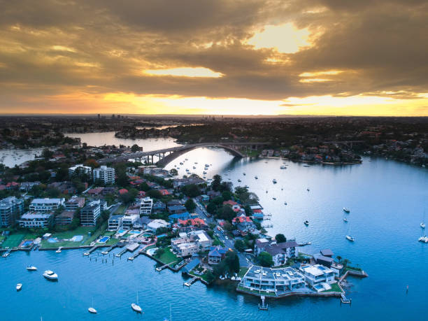 istock Panoramic drone aerial view over Sydney harbour on a cloudy sunset afternoon showing the nice colours of the harbour foreshore 1221114770