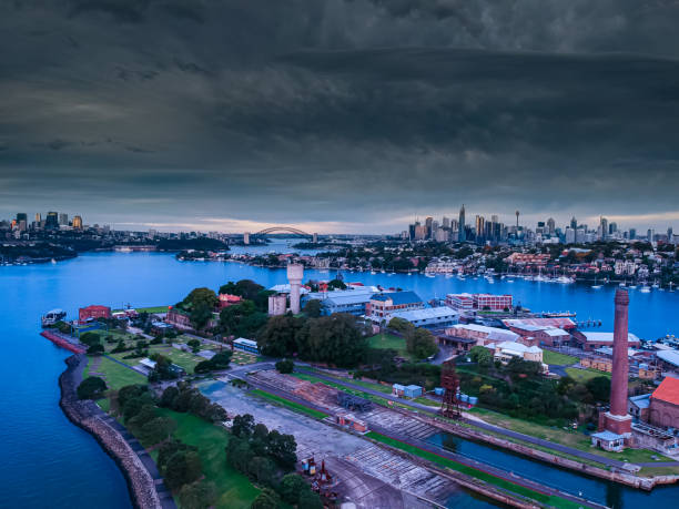 istock Panoramic drone aerial view over Sydney harbour on a cloudy sunset afternoon showing the nice colours of the harbour foreshore 1221114774