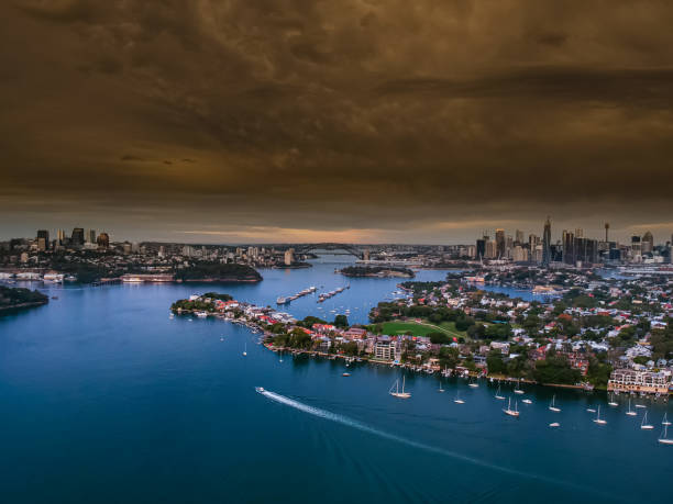 istock Panoramic drone aerial view over Sydney harbour on a cloudy sunset afternoon showing the nice colours of the harbour foreshore 1221114783