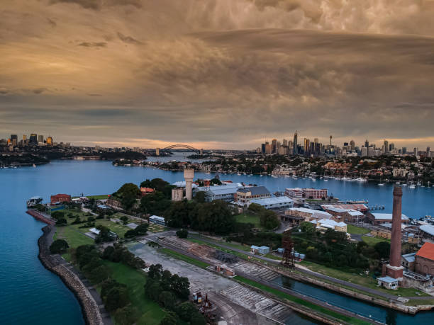 istock Panoramic drone aerial view over Sydney harbour on a cloudy sunset afternoon showing the nice colours of the harbour foreshore 1221114785