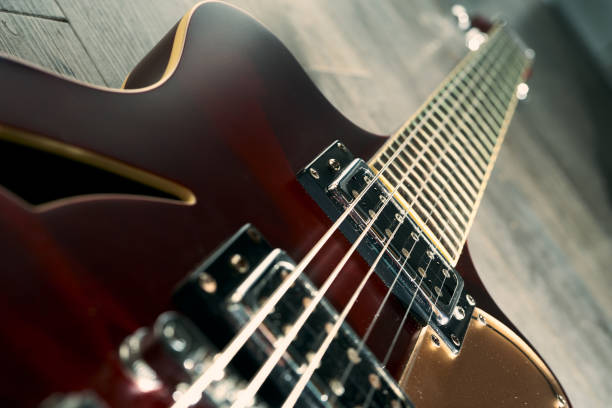 Guitar electric rock background. Headphones, cable jack and capo on wooden table, top view