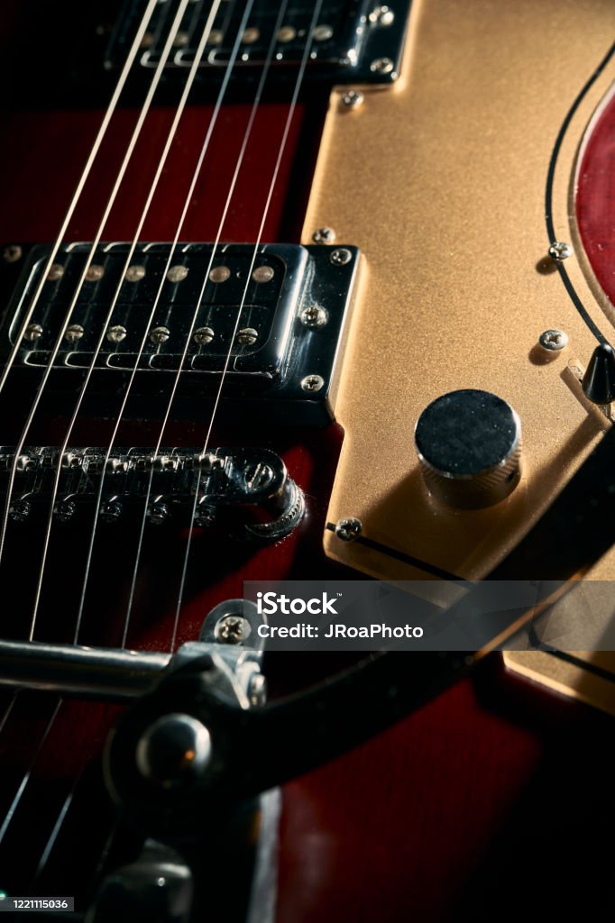Red electric guitar body with a tremolo bar Red retro semi hollow electric guitar body with tremolo bar and beige pick guard Early Rock & Roll Stock Photo
