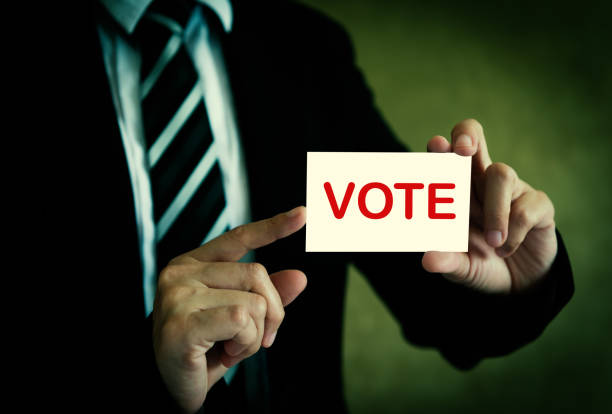 istock Businessman showing vote card 1221117208
