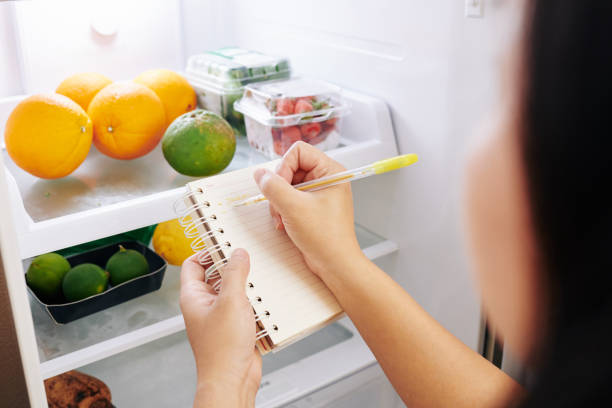 istock Woman making shopping list 1221117329