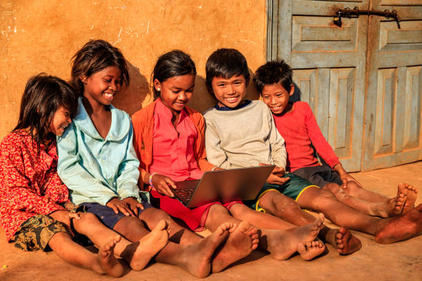istock Happy Cambodian children using laptop on a schoolyard, Cambodia 1221123991