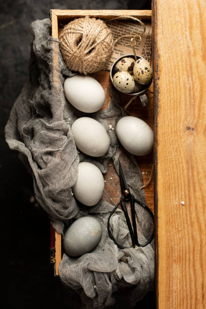 istock Fresh boiled chicken eggs in wooden cell. Top view. 1221125039