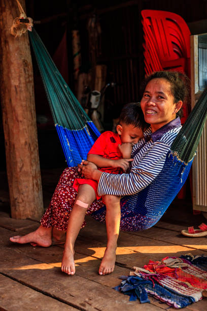 Cambodian mother with her son lie on the hammock, Cambodia Cambodian mother with her son resting on the hammock, Cambodia. cambodian ethnicity stock pictures, royalty-free photos & images