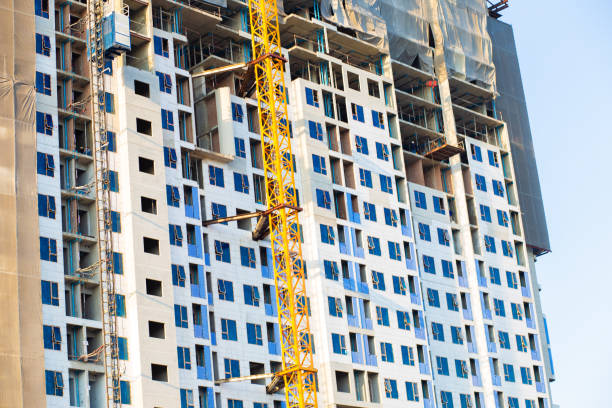 istock High rise construction building site with crane against blue sky 1221127083