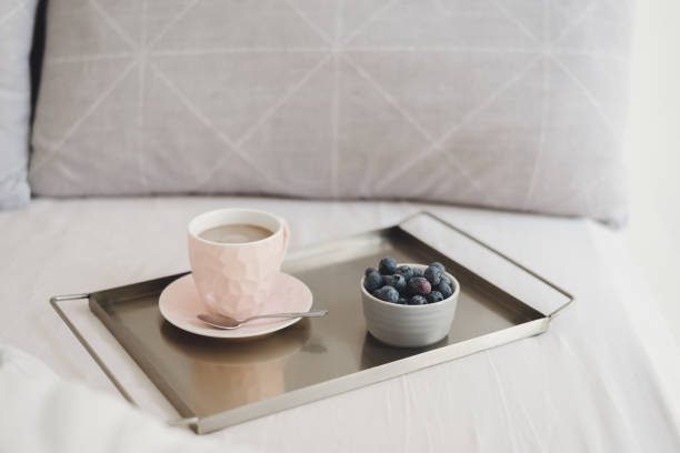 istock Breakfast in bed: coffee with milk and fresh blueberries on a metal tray. Weekend relax 1221127792
