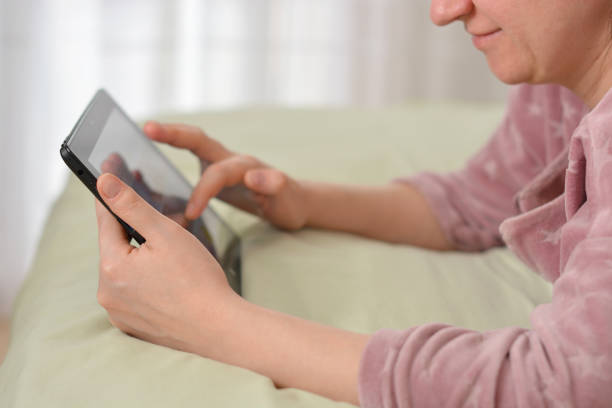 istock Relaxed woman using tablet pc in the morning  at home 1221128487