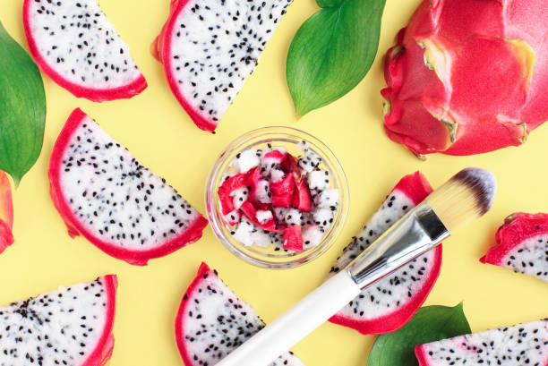 istock Dragon fruit slices top view bright yellow background, mashed in jar, natural juicy summer skincare 1221129786