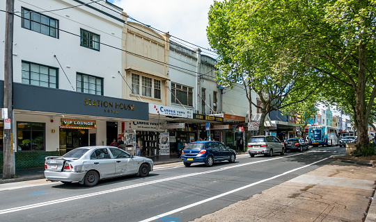 Sydney, Australia - Oct 11, 2019: Vehicle traffic along the popular Beamish Street in the suburb of Campsie. Some people walking along the shop fronts.
