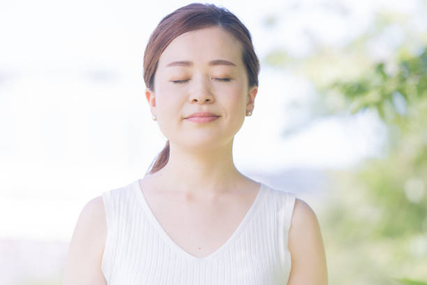 istock Asian young woman surrounded by greenery 1221131838