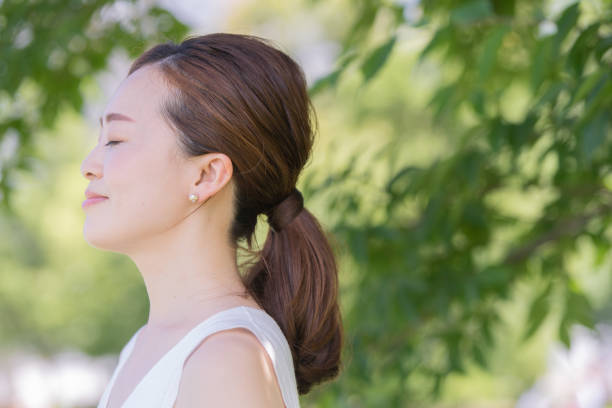 istock Asian young woman surrounded by greenery 1221131880