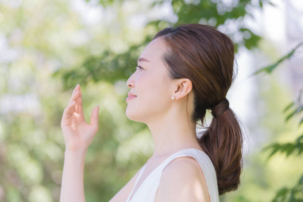 istock Asian young woman surrounded by greenery 1221132000