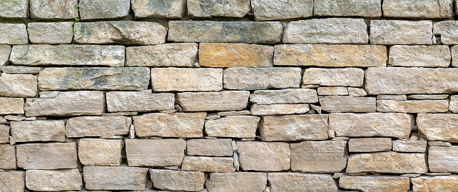 ashlar aligned and stacked to form a stone wall