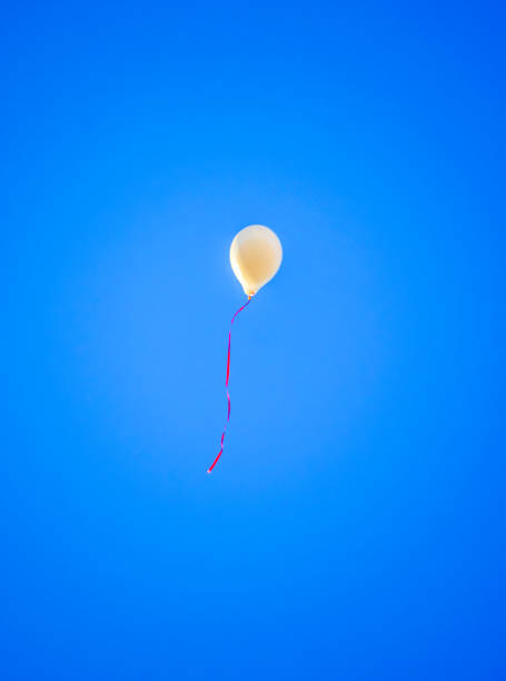 istock colorful balloons flying in the blue sky 1221133270