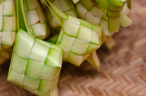 istock ketupat casing and rice in bamboo container 1221133314