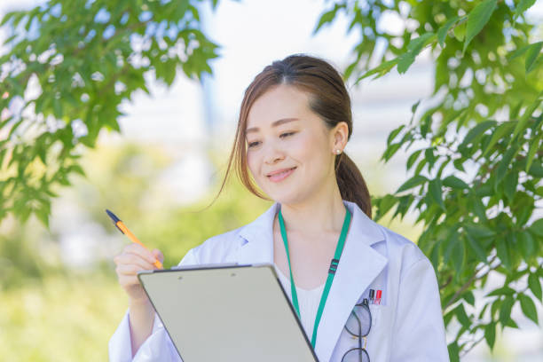 istock asian woman in white coat 1221133403
