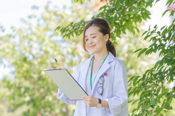 istock asian woman in white coat 1221133573