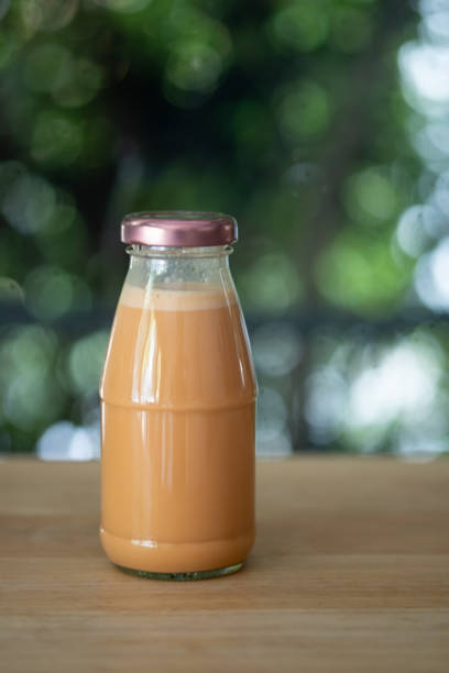 istock Cold Thai milk tea in a glass bottle put on wood table 1221134213