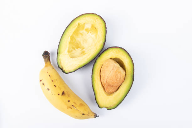 Fresh Avocado with banana on white background. Healthy Fruit Concept.