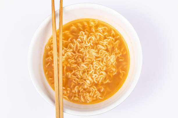 istock A bowl of cooked instant noodle curry taste on white background. 1221140440
